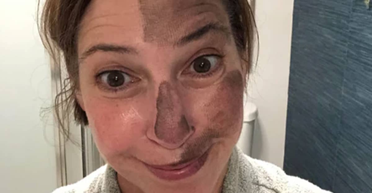 a man wearing glasses and smiling at the camera