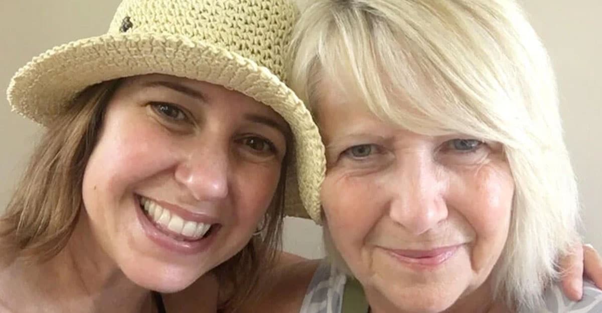 a woman wearing a hat and smiling at the camera